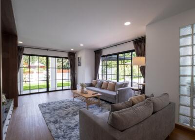 Modern living room with large windows and sliding glass doors