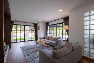 Modern living room with large windows and sliding glass doors