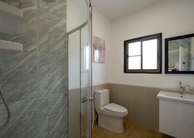 Modern bathroom with shower, toilet, and vanity