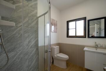 Modern bathroom with shower, toilet, and vanity