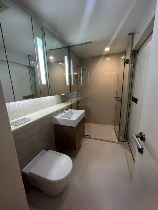 Modern bathroom with glass shower and large mirror