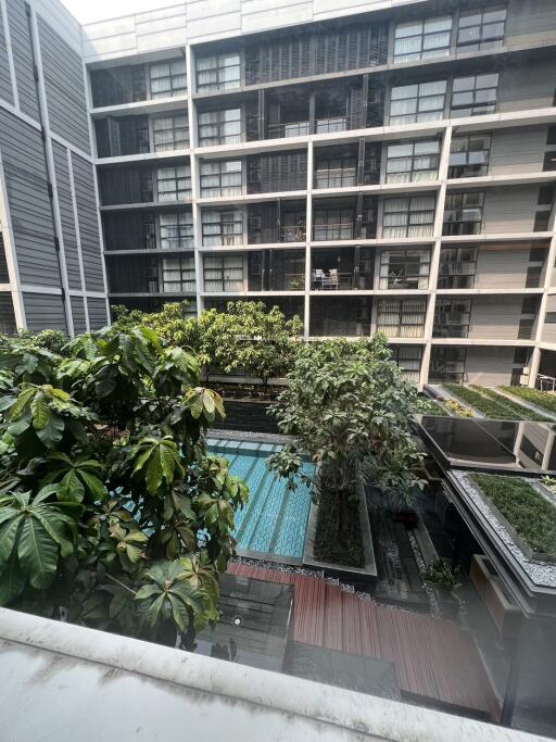 Photo of an apartment building with a swimming pool