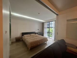 Modern bedroom with large window and sliding partition