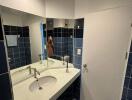 Bathroom with white countertop and blue tiled walls