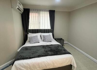 modern bedroom with a bed, curtains, and bedside table