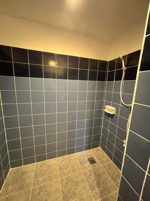 Tiled bathroom with shower area