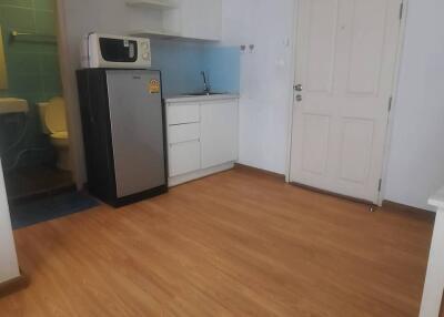 Compact kitchen with appliances and wooden flooring