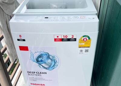 Laundry area with top-load washing machine