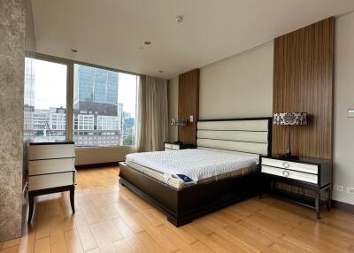 Modern bedroom with large windows and city view