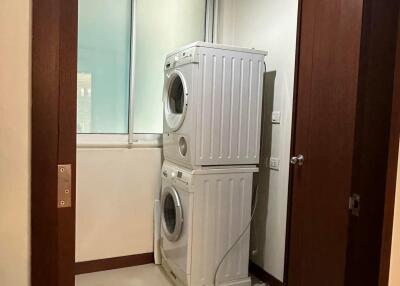 Laundry room with stacked washer and dryer units