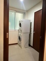 Laundry room with stacked washer and dryer units