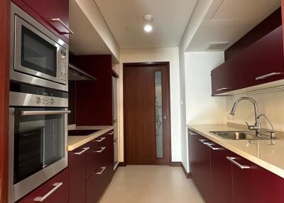 Modern kitchen with red cabinetry and stainless steel appliances