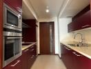 Modern kitchen with red cabinetry and stainless steel appliances