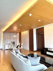 Modern living room with wooden ceiling and open dining area