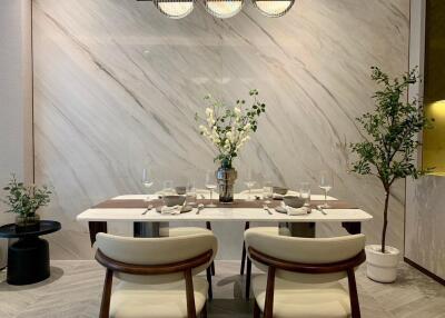 Modern dining room with marble accent wall and elegant table setup