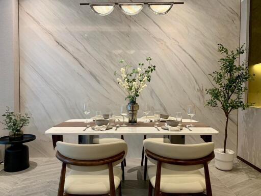 Modern dining room with marble accent wall and elegant table setup