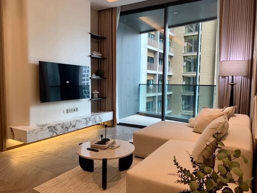 Modern living room with a sectional sofa and a balcony view