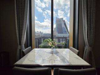 Dining area with a marble table and city view