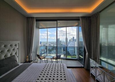 Spacious bedroom with balcony and city view