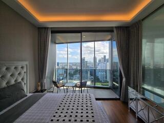 Spacious bedroom with balcony and city view