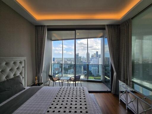 Spacious bedroom with balcony and city view