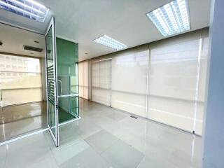 Modern office space with glass partitions and ample natural light