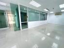 spacious office area with glass partition