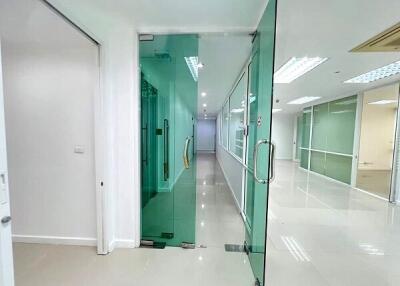 Modern office hallway with glass partitions