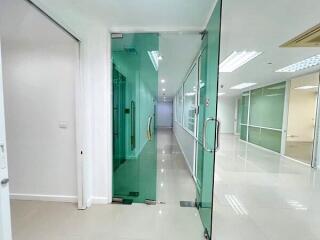 Modern office hallway with glass partitions