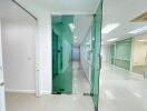 Modern office hallway with glass partitions