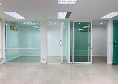 Modern office space with glass partitions and bright lighting