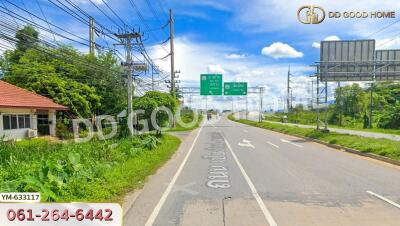 View of a road with highway signs and greenery