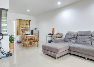 Spacious living area with dining table and modern sofa