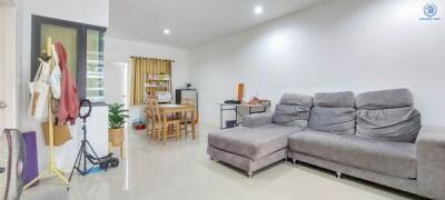 Spacious living area with dining table and modern sofa