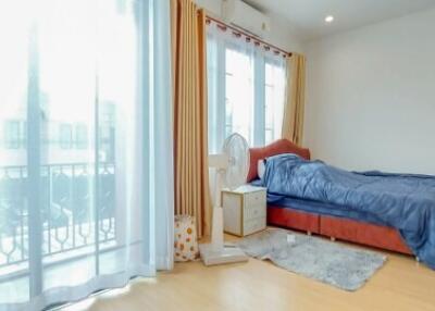 Spacious bedroom with large window and balcony access