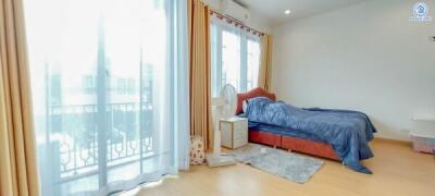 Spacious bedroom with large window and balcony access