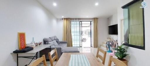 Spacious and well-lit living room with dining area