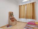 Bedroom with a single bed, window with curtains, and a small altar.