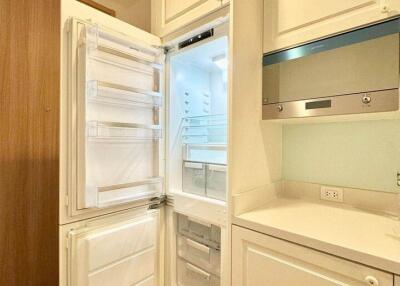 Modern kitchen with built-in appliances and wooden floor