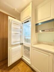 Modern kitchen with built-in appliances and wooden floor