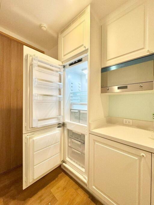 Modern kitchen with built-in appliances and wooden floor