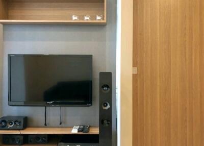 Modern living room with TV and wooden shelves