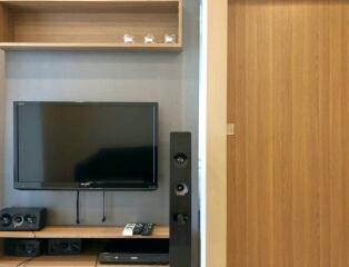 Modern living room with TV and wooden shelves