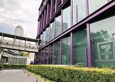 Exterior view of a commercial building with purple framing and large glass windows.