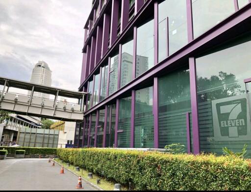 Exterior view of a commercial building with purple framing and large glass windows.