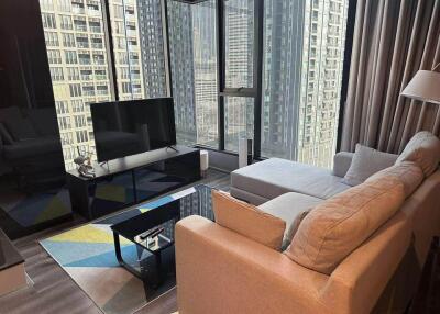 Modern living room with a large window and city view