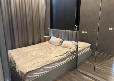 Modern bedroom with mirrored wardrobe and cozy bed