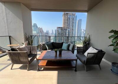 Spacious balcony with comfortable seating and city view