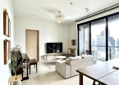 Modern living room with large windows and city view.