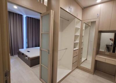 Spacious bedroom with large windows, built-in closet, and dressing table